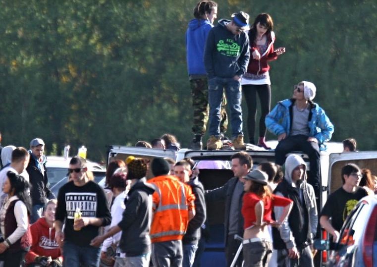 Youth Stand on a Car at an Illegal Rave Party in the UK