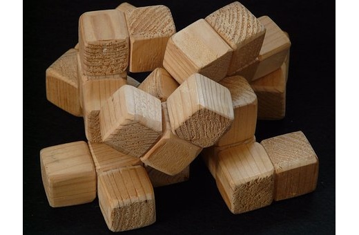 Wooden puzzle pieces in a black background