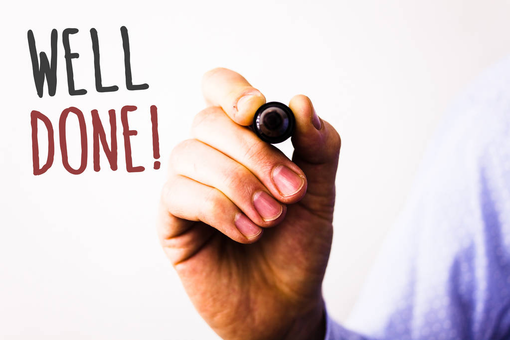 Conceptual hand writing showing Well Done Motivational Call. Business photos text Good Job Great Results Positive EvaluationMan holding pen pointing idea message black red letters white background.