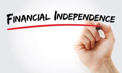 Hand writing Financial independence with marker, concept background